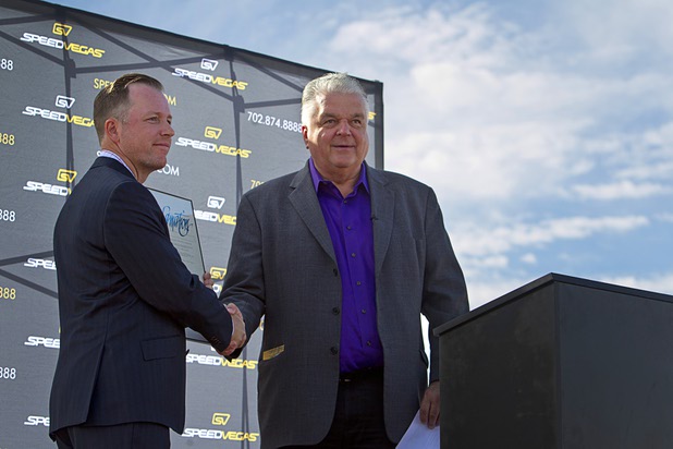 Clark County Commission Chairman Steve Sisolak, right, presents a proclamation to Aaron Fessler, co-founder and CEO of Speed Vegas, during a ground breaking ceremony for Speed Vegas, a $30 million, 90-acre racetrack project on Las Vegas Boulevard south of the M Resort, Monday, Sept. 21, 2015. The project is expected to open in early 2016.