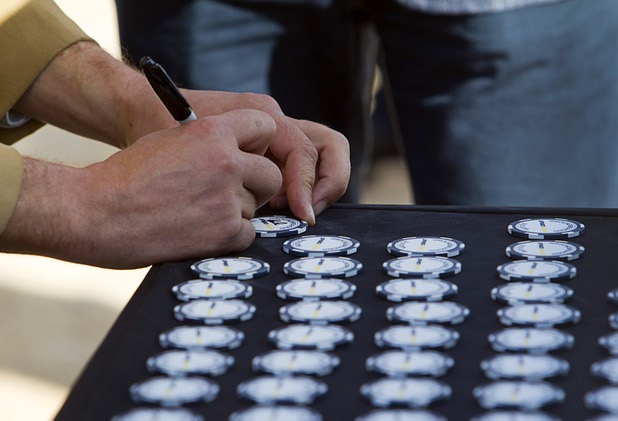 A woman signs a commemorative chip during a ground breaking ceremony for Speed Vegas, a $30 million, 90-acre racetrack project on Las Vegas Boulevard south of the M Resort, Monday, Sept. 21, 2015. The chips will be displayed on a wall at the track's Welcome Center. The project is expected to open in early 2016.