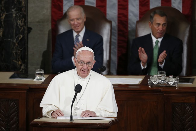 Pope Francis addresses a joint meeting of Congress on Capitol Hill in Washington, Thursday, Sept. 24, 2015, making history as the first pontiff to do so. Listening behind the pope are Vice President Joe Biden and House Speaker John Boehner of Ohio.