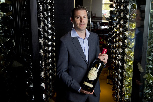 Adam Gomes, owner of Via Brasil Steakhouse, poses at the restaurant's wine room, 1225 S. Fort Apache Rd., Monday Sept. 28, 2015.