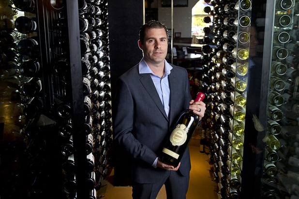 Adam Gomes, owner of Via Brasil Steakhouse, poses at the restaurant's wine room, 1225 S. Fort Apache Rd., Monday Sept. 28, 2015.