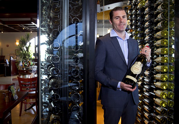 Adam Gomes, owner of Via Brasil Steakhouse, poses at the restaurant's wine room, 1225 S. Fort Apache Rd., Monday Sept. 28, 2015.