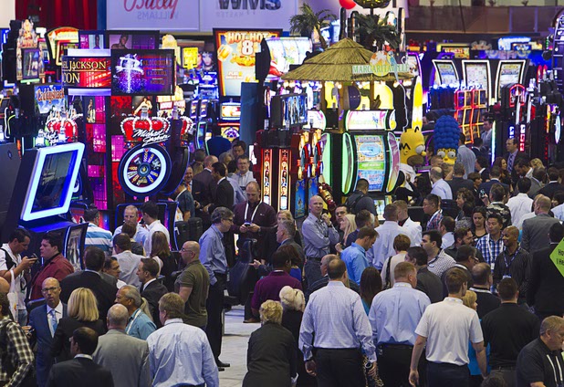 Attendees check out new slot machines as the trade show floors opens during the Global Gaming Expo (G2E) at the Sands Expo Center Tuesday, Sept. 29, 2015.