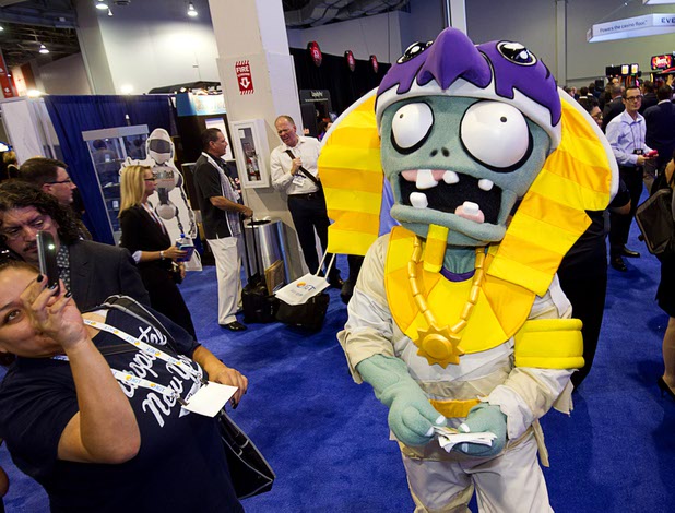 A woman photographs a character from IGT's Plants vs. Zombies 3D slot machine during the Global Gaming Expo (G2E) at the Sands Expo Center Tuesday, Sept. 29, 2015.