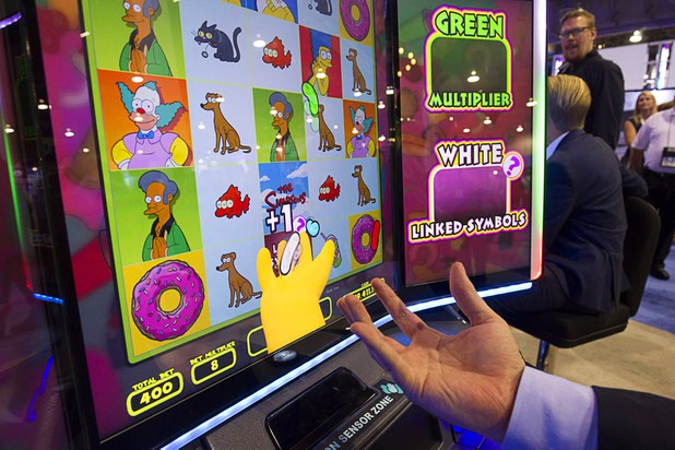 A camera captures the location of a player's hand and copies it into a bonus round of a Simpsons slot machine at the Scientific Games booth during the Global Gaming Expo (G2E) at the Sands Expo Center Tuesday, Sept. 29, 2015.