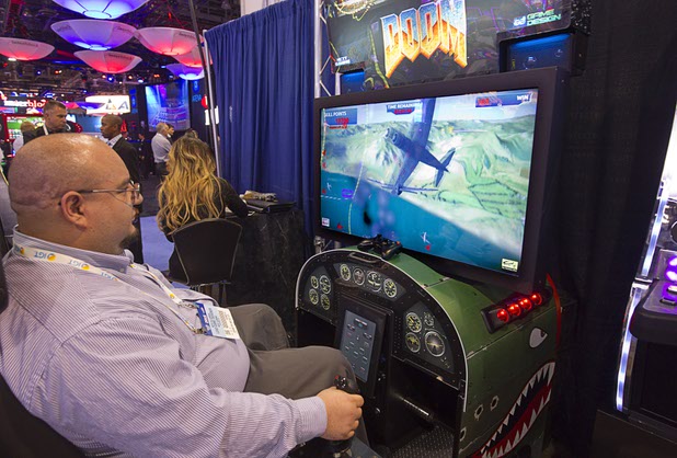 Beto Villarreal plays a skill-based air combat slot game at the Next Gaming booth during the Global Gaming Expo (G2E) at the Sands Expo Center Tuesday, Sept. 29, 2015. The machine plays a predetermined wager every time you shoot down an enemy plane, he said.