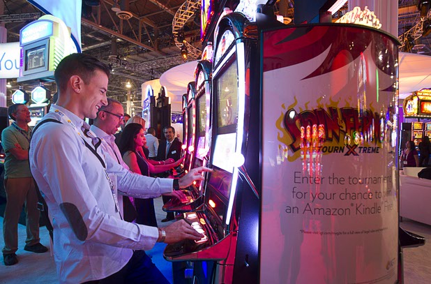 Attendeees try out IGT's Spin Furno tournament slot machines during the second day of the Global Gaming Expo (G2E) in the Sands Expo Center Wednesday, Sept. 30, 2015. The Spin Furno system is the the worlds first automated tournament technology system for a spinning reel cabinet, a representative said.
