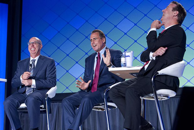 Gavin Isaacs, left, CEO of Scientific Games, and Bo Bernhard, right, executive director of the International Gaming Institute at UNLV, laugh as Mark Frissora, CEO/president of Caesars Entertainment, talks about beer pong during a CEO round table at the Global Gaming Expo (G2E) in the Sands Expo Center Wednesday, Sept. 30, 2015.