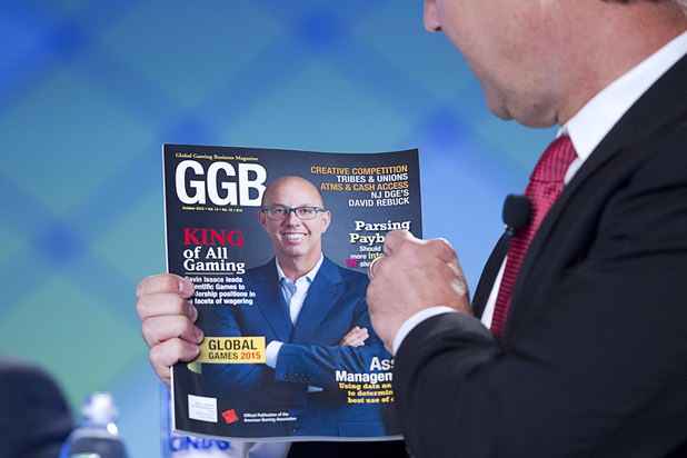 Bo Bernhard, executive director of the International Gaming Institute at UNLV, holds a magazine featuring Gavin Isaacs, CEO of Scientific Games, during a CEO round table at the Global Gaming Expo (G2E) in the Sands Expo Center Wednesday, Sept. 30, 2015.
