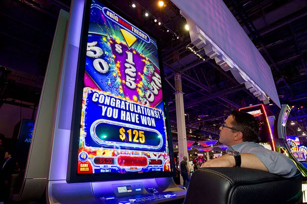 A players tries out "The Big Bang Theory" slot machine in the Aristocrat booth during the Global Gaming Expo (G2E) in the Sands Expo Center Thursday Oct. 1, 2015.