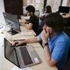 Draftpot co-founder and CEO Joey Levy, foreground, works with co-founder and CTO Joshua Hughes, center, and co-founder and developer Jessica Vandebon at the Fantasy Football operation's workspace, Wednesday, Sept. 30, 2015, in New York. 