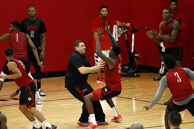 Todd Simon, center, associate head coach, runs drills with players during the Rebels’ first basketball practice of the season Monday, Oct. 5, 2015, at Mendenhall Center at UNLV.