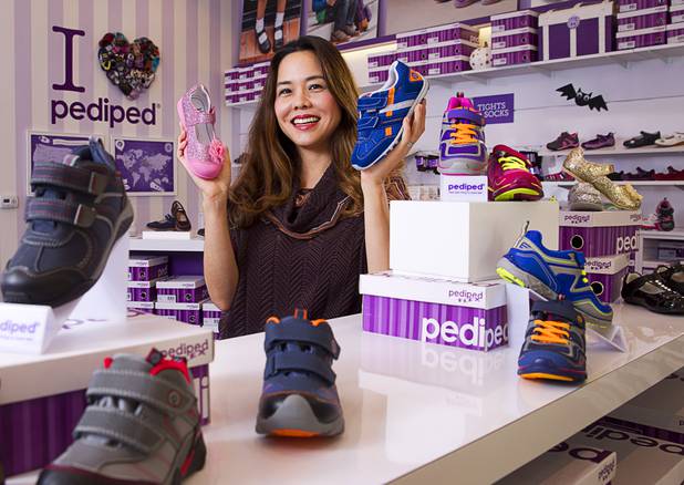 Angela Edgeworth, president and founder of Pediped Footwear, poses in the Pediped store at Town Square Tuesday, Oct. 6, 2015.