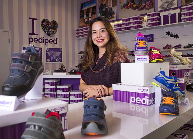Angela Edgeworth, president and founder of Pediped Footwear, poses in the Pediped store at Town Square Tuesday, Oct. 6, 2015.