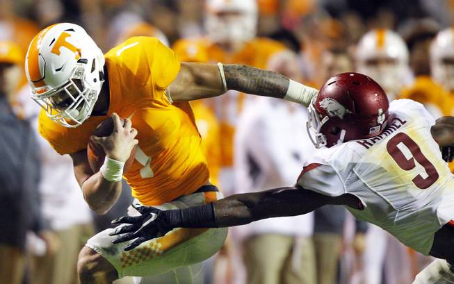 Tennessee running back Jalen Hurd (1) tries to get away from Arkansas defensive back Santos Ramirez (9) during the first half of an NCAA college football game Saturday, Oct. 3, 2015 in Knoxville, Tenn.