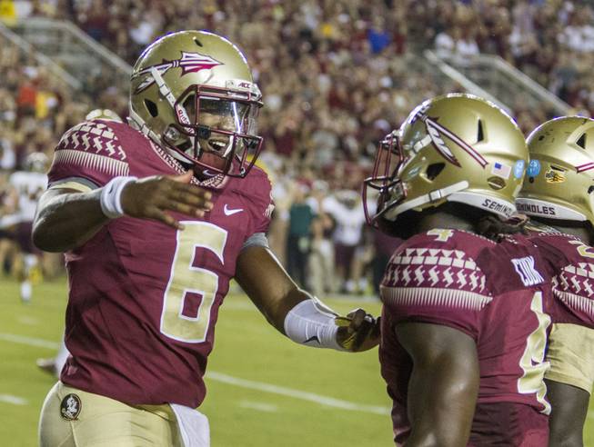 Florida State quarterback Everett Golson, left, celebrates the team's first touchdown with Dalvin Cook, during the first half of an NCAA college football game against Texas State in Tallahassee, Fla., Saturday, Sept. 5, 2015.