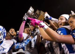 Basic players celebrate their Henderson Bowl victory at Green Valley High School on Friday, Oct. 9, 2015.