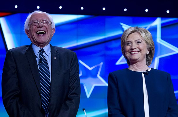 Bernie Sanders, left, laughs with Hillary Clinton as the candidates take the stage during the CNN Democratic Presidential Debate at the Wynn Las Vegas Tuesday, Oct. 13, 2015.