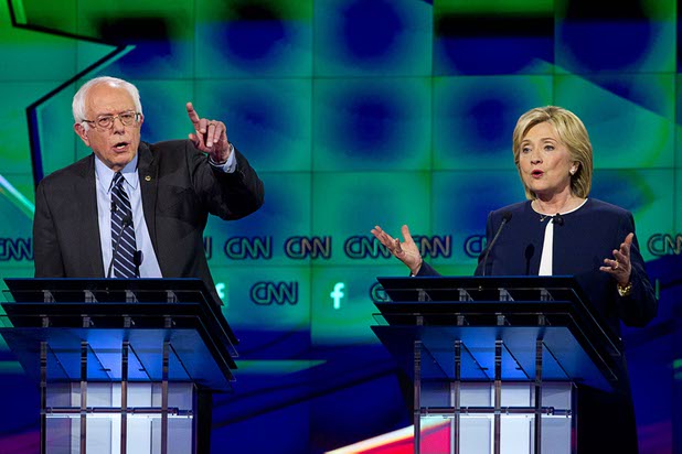 Bernie Sanders, left, and Hillary Clinton try to responds to a question during the CNN Democratic Presidential Debate at the Wynn Las Vegas Tuesday, Oct. 13, 2015.