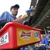 A beer vender pours Bud Light into a cup at Wrigley Field before Game 4 in baseball's National League Division Series between the Chicago Cubs and the St. Louis Cardinals, Tuesday, Oct. 13, 2015, in Chicago. Anheuser Busch InBev clinched a deal Tuesday to take over SABMiller in a bid to stave off the megabrewers' most serious problems: the surge in popularity of craft brews and weakening sales in the rich markets of the U.S. and Europe.