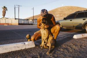 Paul Carter kisses his dog Nylah at Tecopa Hot Springs Campground on October 1, 2015.