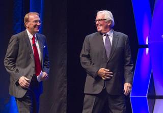 Chris Maathius, left, sports director at KLAS TV, and prospective NHL owner Bill Foley II, take the stage during the annual Las Vegas Global Economic Alliance dinner at Aria Thursday, Oct. 15, 2015.