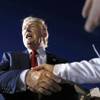 Republican presidential candidate Donald Trump shakes hands during a campaign rally in Tyngsborough, Mass., Friday, Oct. 16, 2015. 