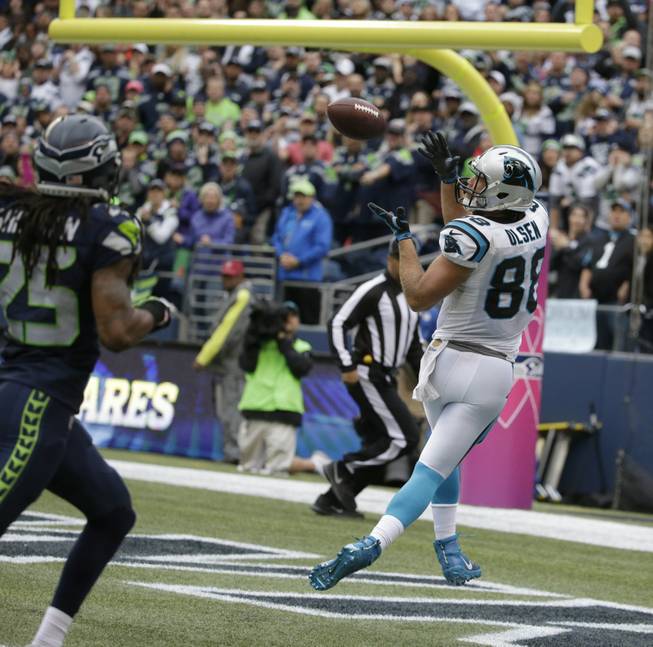 Carolina Panthers tight end Greg Olsen, right, catches a pass for a touchdown ahead of Seattle Seahawks cornerback Richard Sherman in the second half of an NFL football game Sunday, Oct. 18, 2015, in Seattle.