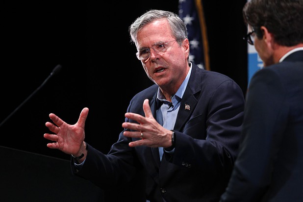 Republican presidential candidate Jeb Bush, left, speaks with Daniel Garza, executive director for The Libre Initiative, during the Libre Initiative's policy forum series, "The Libre Forum: Unlimited Opportunities in a Free Society," at the College of Southern Nevada in North Las Vegas Wednesday, Oct. 21, 2015.