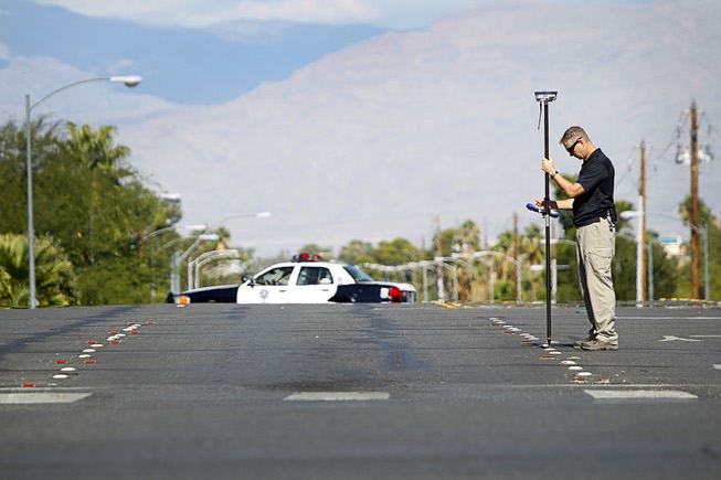 Metro Police Sgt. Richard Strader takes measurements after an auto-pedestrian ...