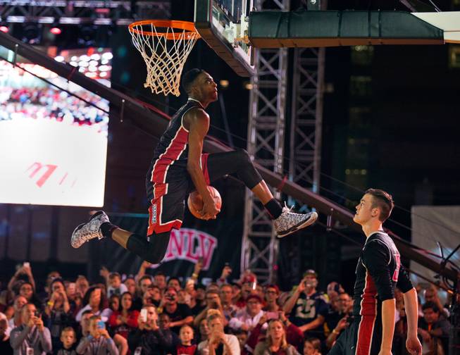 UNLV's Derrick Jones, Jr., 1, passes the ball between his legs on his way to the hoop during a dunk contest apart of the Runnin Rebel Madness basketball season tipoff celebration party downtown at the Las Vegas Events Center on Thursday, October 22,  2015.