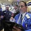 Trader Sal Suarino, right, works on the floor of the New York Stock Exchange, Thursday, Oct. 22, 2015.