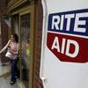 In this June 20, 2011, file photo, a woman exits a Rite Aid store, in Philadelphia.
