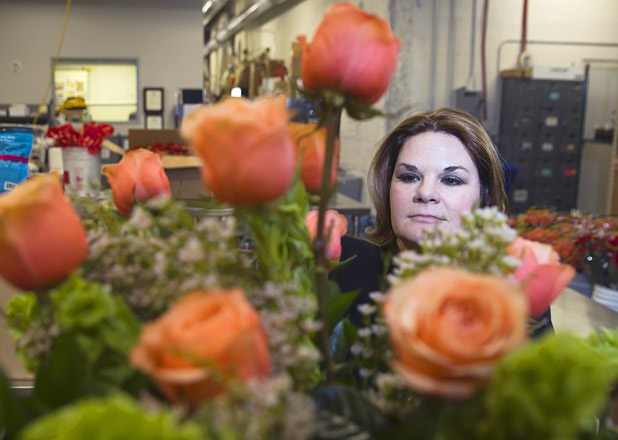 Dana Beatty, director of floral and horticulture at the Venetian/Palazzo, displays an arrangement of Venetian and Palazzo roses at the Palazzo floral department Wednesday, Oct. 28, 2015. The Venetian roses are red and the Palazzo roses are peach-colored.