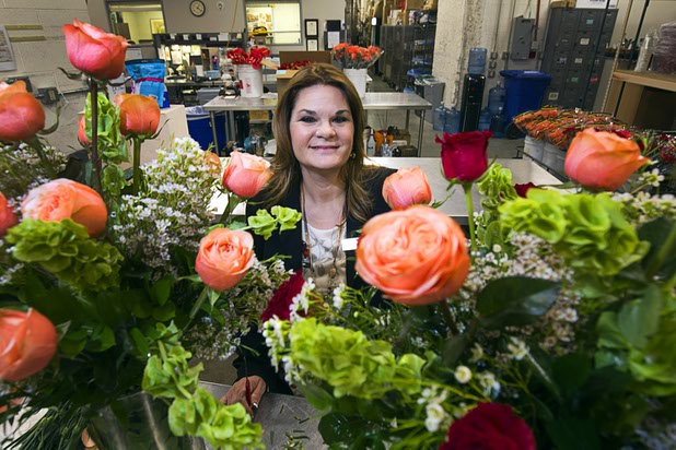 Dana Beatty, director of floral and horticulture at the Venetian/Palazzo, displays an arrangement of Venetian and Palazzo roses at the Palazzo floral department Wednesday, Oct. 28, 2015. The Venetian roses are red and the Palazzo roses are peach-colored.