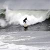 A surfer rides a wave at Ocean Beach, Tuesday, Oct. 27, 2015, in San Francisco. Very high tides and swell arriving from a Pacific storm will combine to bring the possibility of big surf and minor flooding of low-lying points along parts of California's coast, the National Weather Service said Tuesday. 