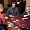 UNLV Harrah Hotel College Center for Gaming Innovation student Taylor Ross, center, and UNLV Center for Gaming Innovation Director Mark Yoseloff play 40 Times Double Down blackjack, a game invented by Ross. 