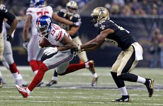 New York Giants wide receiver Odell Beckham (13) pulls in a reception as New Orleans Saints cornerback Delvin Breaux tries to tackle in the first half of an NFL football game in New Orleans, Sunday, Nov. 1, 2015. (AP Photo/Jonathan Bachman)