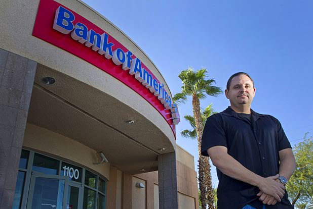 Michael Bondi poses by a Bank of America branch in Henderson Monday, Nov. 2, 2015. Bondi has a federal lawsuit pending against Bank of America and Nationstar Mortgage. 
