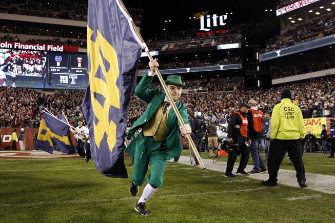 The Notre Dame mascot carries a flag on the field before an NCAA college football game against Temple Saturday, Oct. 31, 2015, in Philadelphia.