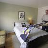 In this Friday, Oct. 16, 2015, photo, Bruce Bennett folds a blanket in a room that he makes available to rent in his home in San Francisco. 