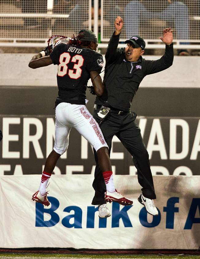 UNLV's Devonte Boyd (83) celebrates in the air with head coach Tony Sanchez  after a long reception and touchdown versus Hawaii at Sam Boyd Stadium on Saturday, November 7, 2015.