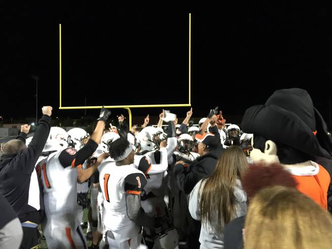 Chaparral players and coaches celebrate after their upset win over host Faith Lutheran, Friday, Nov. 6, 2015. 