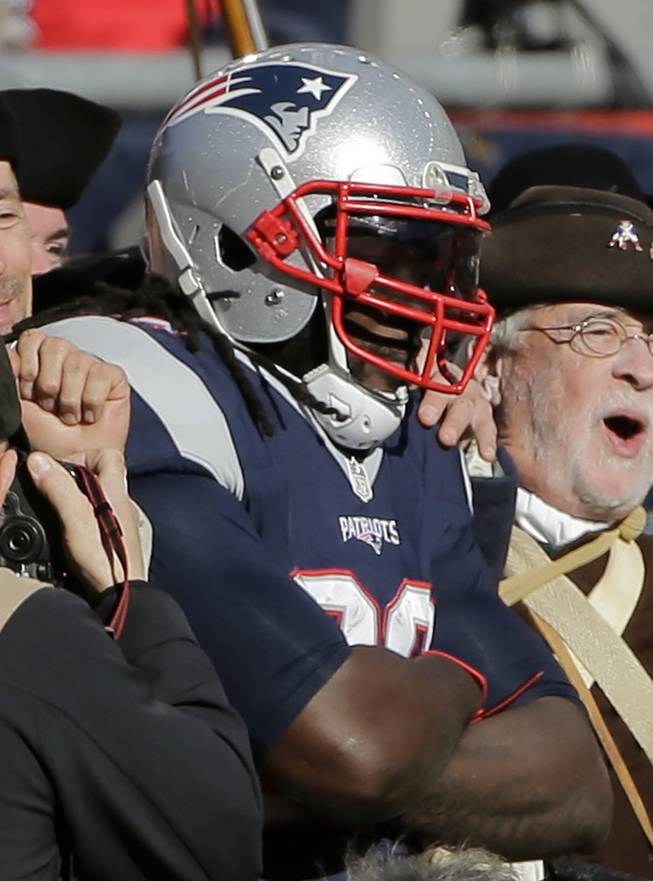 New England Patriots running back LeGarrette Blount strikes a pose with members of the End Zone Militia after scoring a touchdown against the Washington Redskins during the first half of an NFL football game, Sunday, Nov. 8, 2015, in Foxborough, Mass. (AP Photo/Steven Senne)