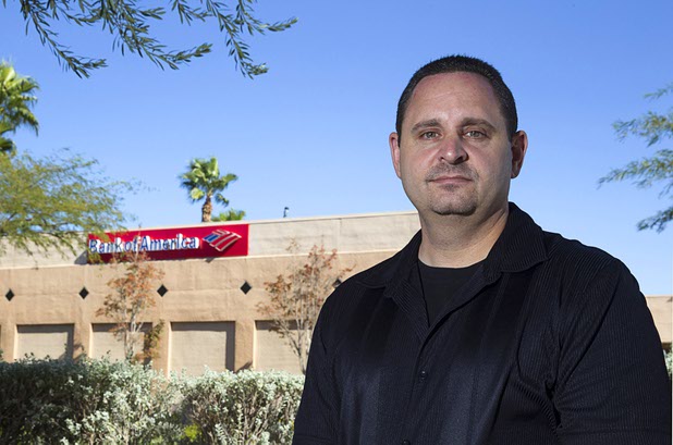 Michael Bondi poses near a Bank of America branch in Henderson Monday, Nov. 2, 2015. Bondi has a federal lawsuit pending against Bank of America and Nationstar Mortgage. 
