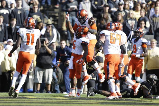 Illinois quarterback Wes Lunt (12) celebrates a touchdown with offensive lineman Chris Boles (55) during the first half of an NCAA college football game against Purdue in West Lafayette, Ind., Saturday, Nov. 7, 2015.
