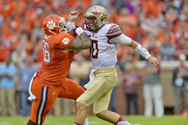 Florida State quarterback Sean Maguire, right, is pressured by Clemson's Scott Pagano during the first half of an NCAA college football game, Saturday, Nov. 7, 2015, in Clemson, S.C.