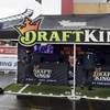 In this Sunday, Oct. 25, 2015, photo, workers set up a DraftKings promotions tent in the parking lot of Gillette Stadium in Foxborough, Mass., before a game between the New England Patriots and New York Jets.