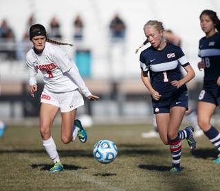 Arbor View Forward Sierra Vincente (1) challenges for the ball against Coronado Defender Angelica Morris (20) during the NIAA State Girls Soccer Championship between the Arbor View Aggies and Coronado Cougars at North Valleys High School in Reno, Nevada.