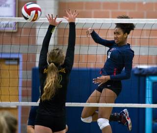 Coronado's Olivia Keller (4) smashes the ball over the net past the Bishop Manogue defense during the 2015 NIAA Division 1 Nevada State High School Girls Volleyball Championship on Saturday, November 14, 2015.